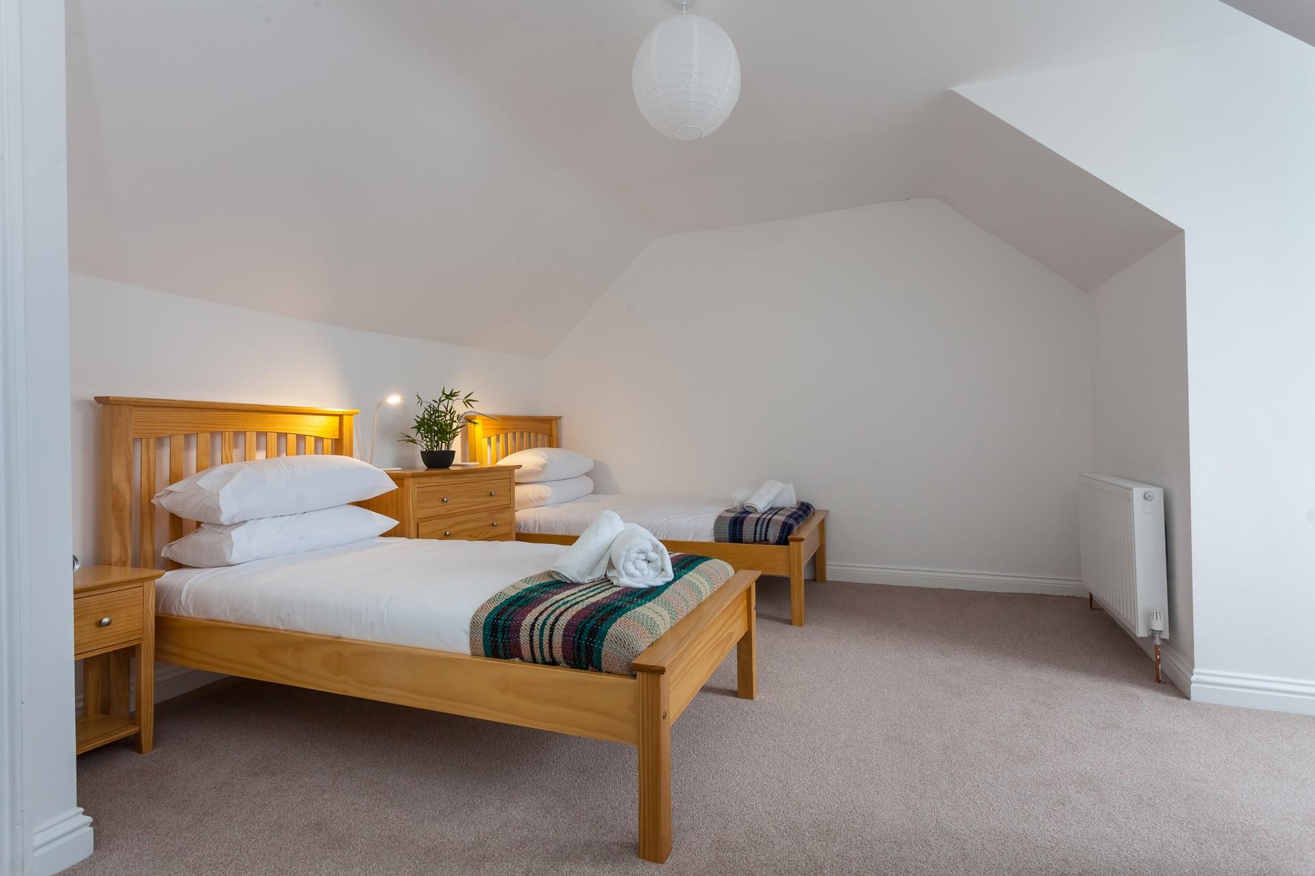 Put the kids to bed in the twin room, exhausted after a day of fun on the beach.