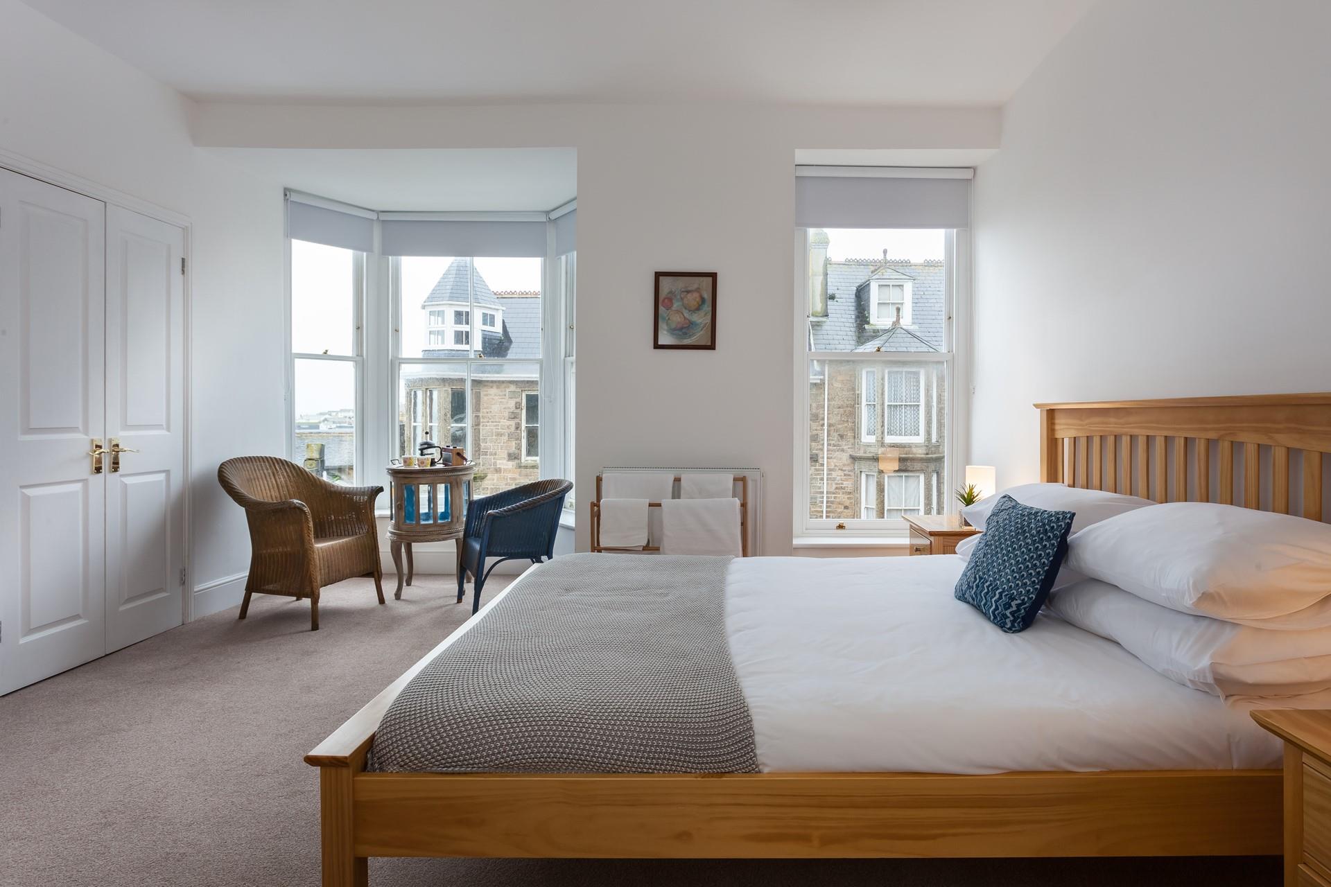 Wake up to glimpses of the sea from the bedroom.