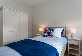 Bedroom 4 has a single bed and is decorated in a blue beachside theme.