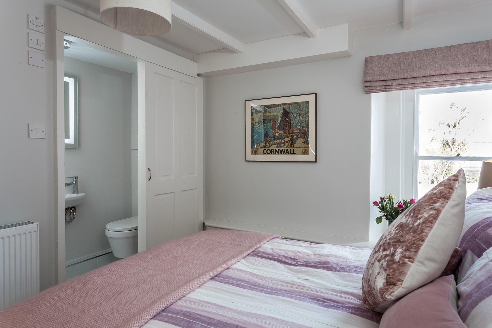 Bedroom 1 with double bed and en suite shower.