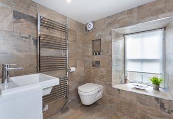The modern bathroom is spacious and well-equipped to get ready each morning.