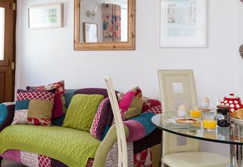 The patchwork sofa is a comfortable spot for relaxing after a tasty breakfast.