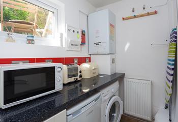 Tucked behind the kitchen you'll find the utility room with kitchen and washing appliances. 
