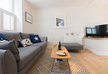 The living area offers a snug space to indulge in an evening of films or board games.