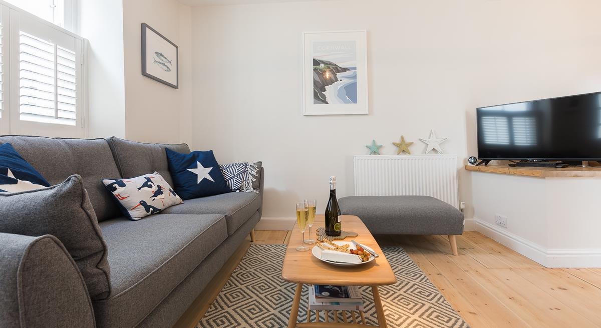 The living area offers a snug space to indulge in an evening of films or board games.