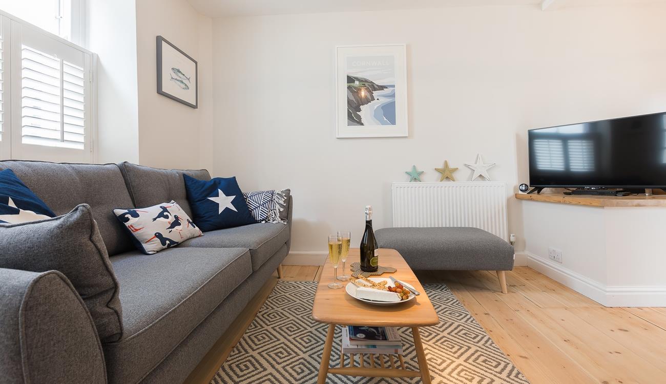 The living area offers a snug space to indulge in an evening of films or board games.