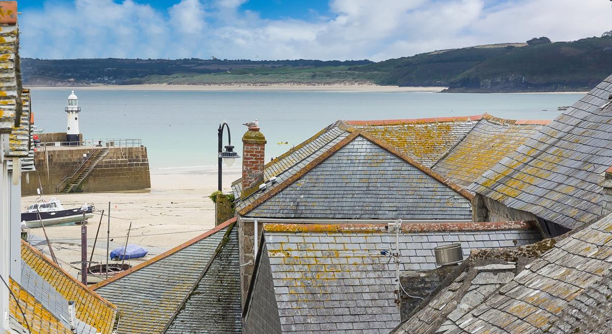 Bedroom 2 offers a glimpse of the sea across the quaint St Ives rooftops.