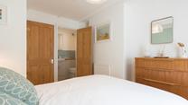 A small en suite bathroom provides additional space to get ready or freshen up.
