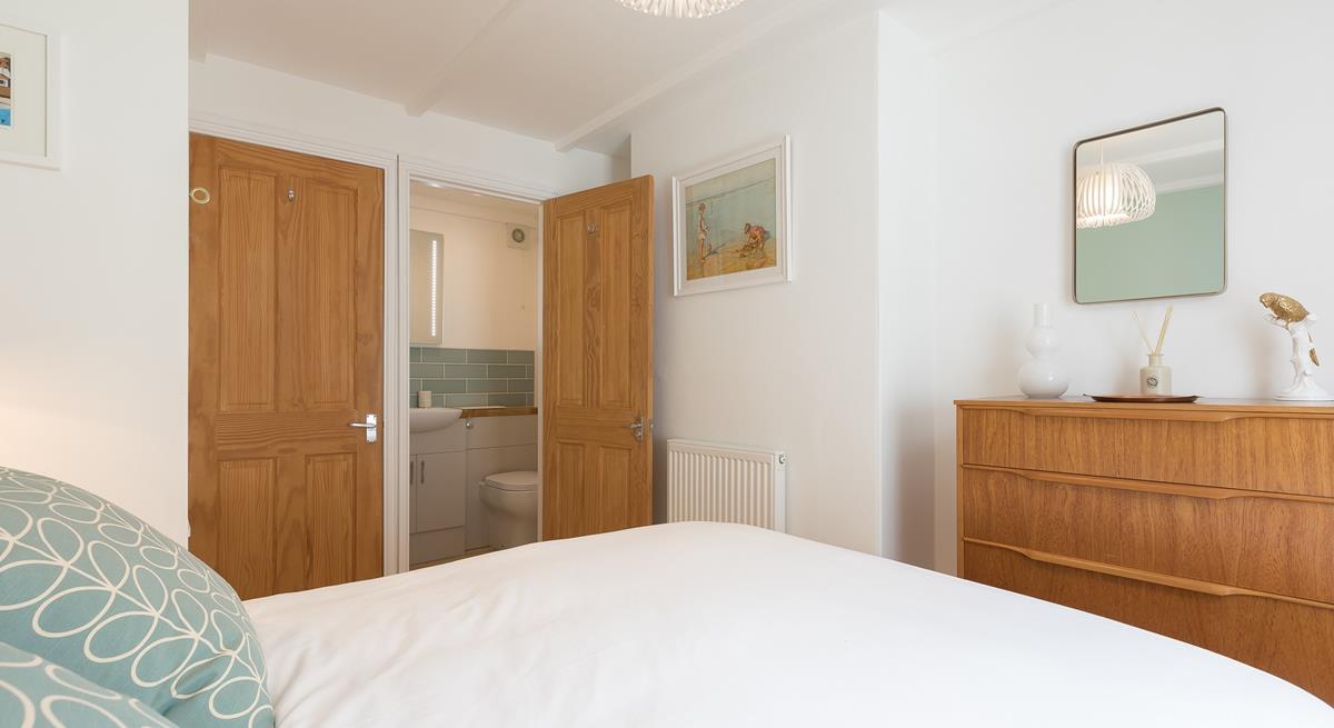 A small en suite bathroom provides additional space to get ready or freshen up.