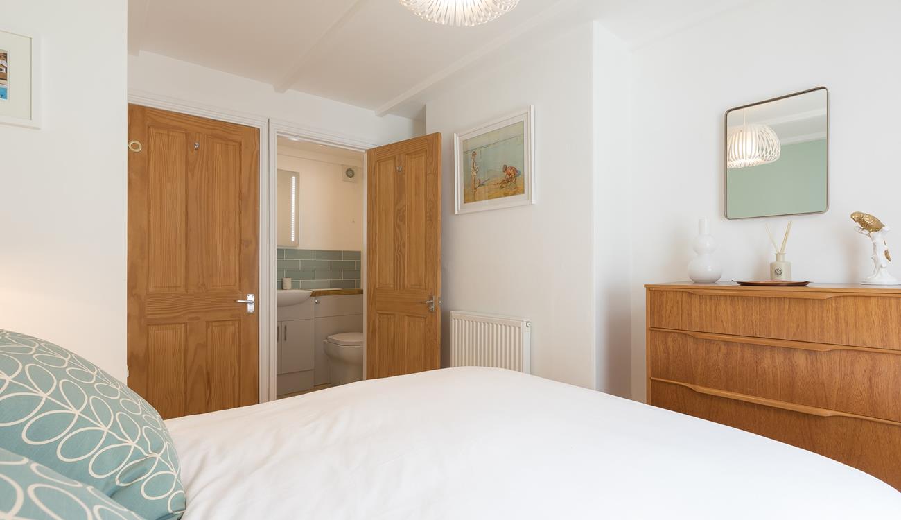 A small en suite bathroom provides additional space to get ready or freshen up.