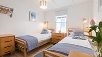 Twin rooms with classic furniture and minimalistic decor are perfect for both children and teenagers.