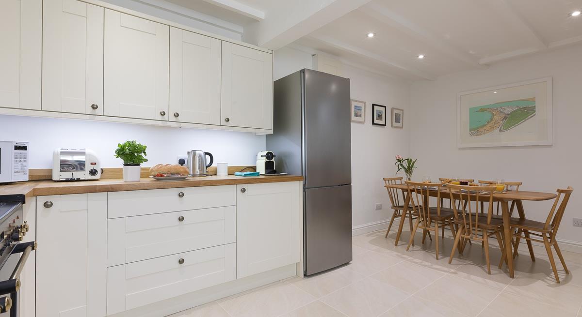 Beautifully designed, the kitchen is well-equipped with everything you could need and more!