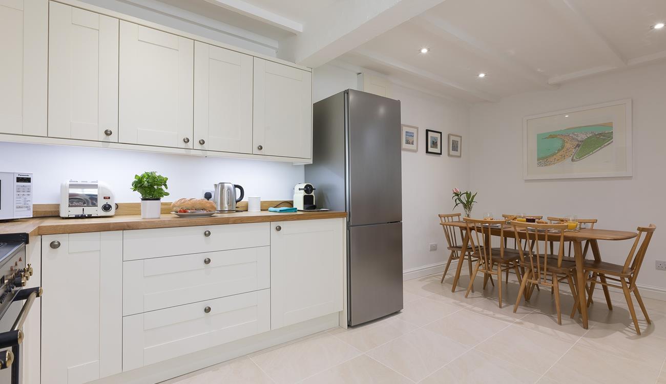 Beautifully designed, the kitchen is well-equipped with everything you could need and more!