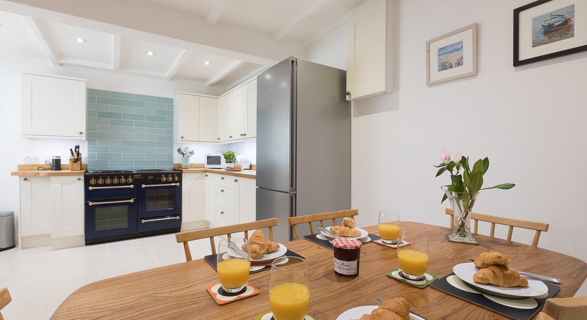 The kitchen/dining area offers ample space for families to enjoy meals together and make lasting memories. 