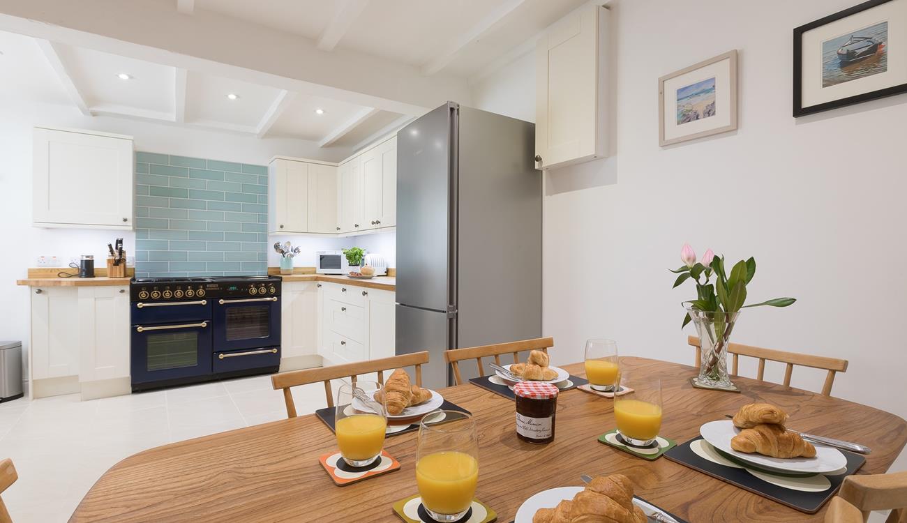 The kitchen/dining area offers ample space for families to enjoy meals together and make lasting memories. 