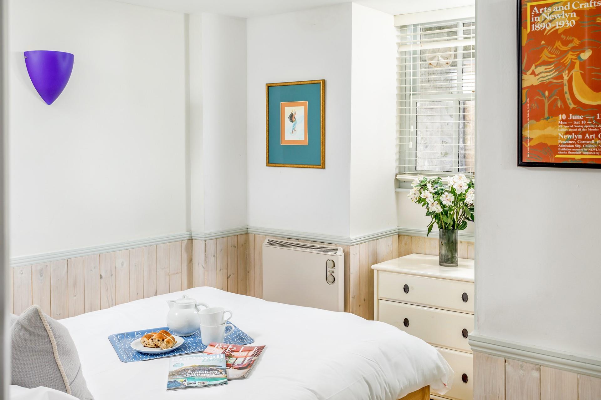 Crisp sheets and a calming colour palette welcome you into the bedroom.