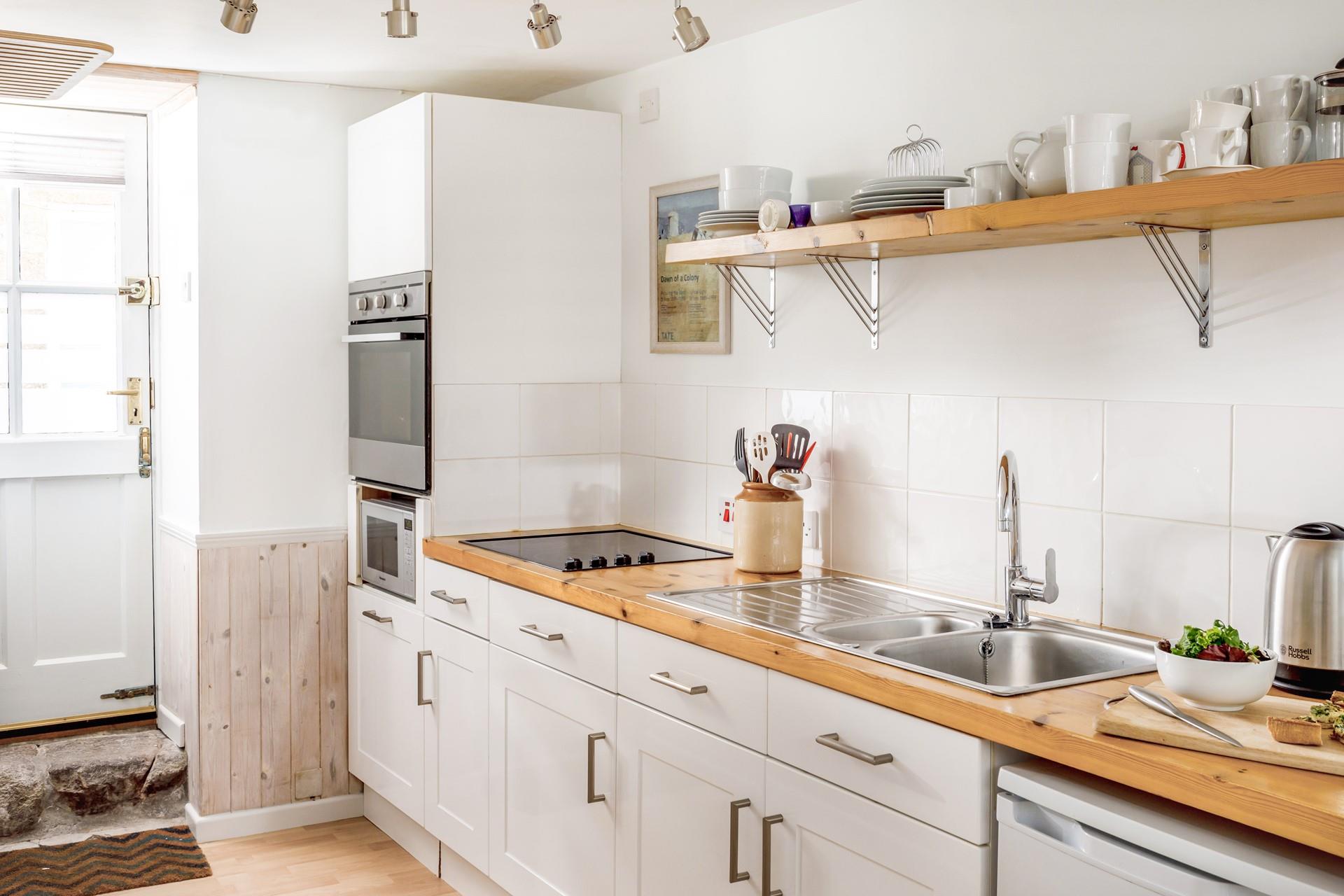 The stunning kitchen has a chic, country vibe and is perfectly equipped for whipping up delicious meals!