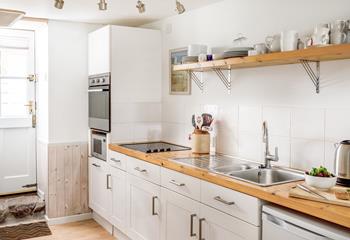 The stunning kitchen has a chic, country vibe and is perfectly equipped for whipping up delicious meals!