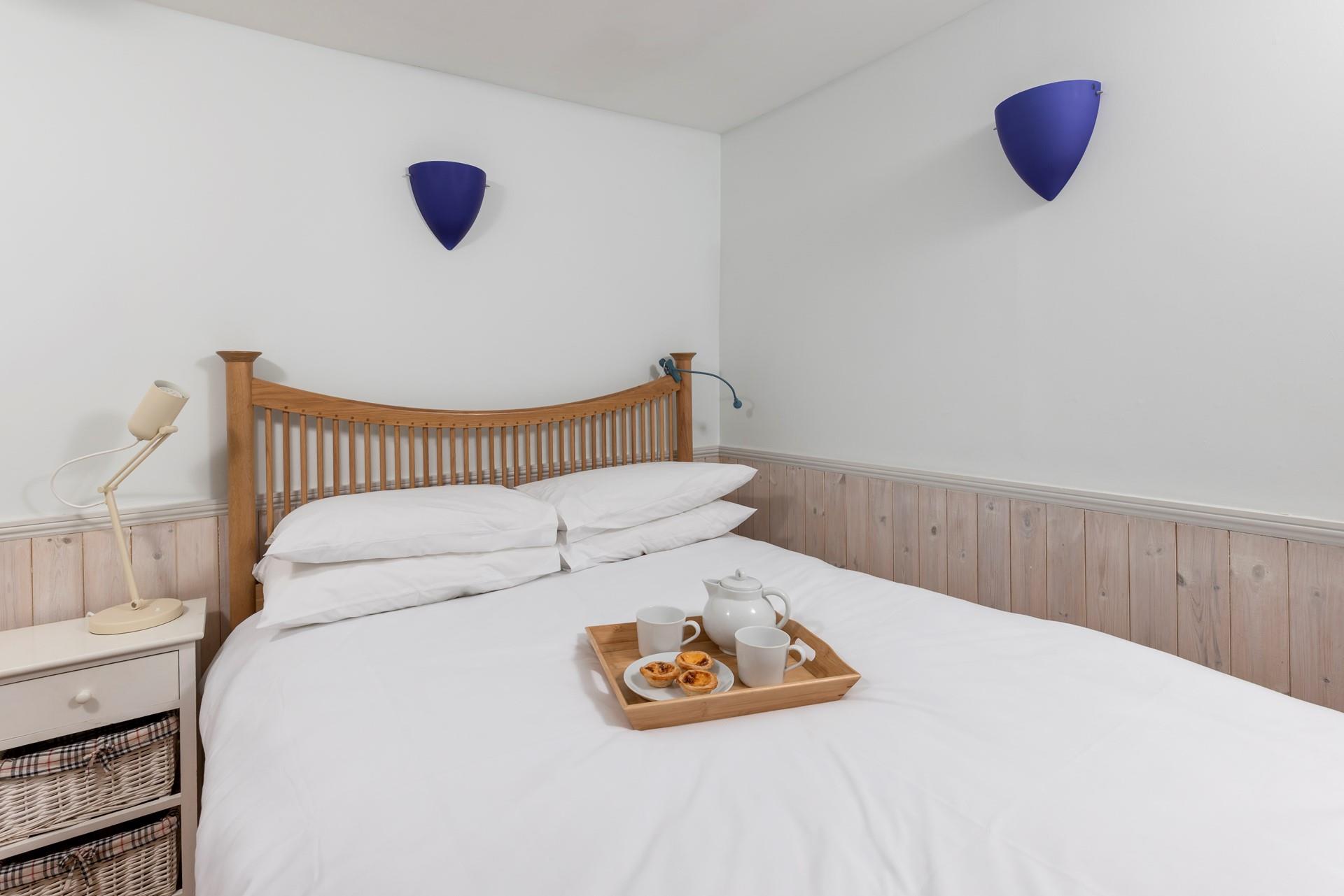 Crisp sheets and a calming colour palette welcome you into the bedroom.