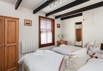 Exposed beams in the twin room exude an enchanting cottage feeling. 