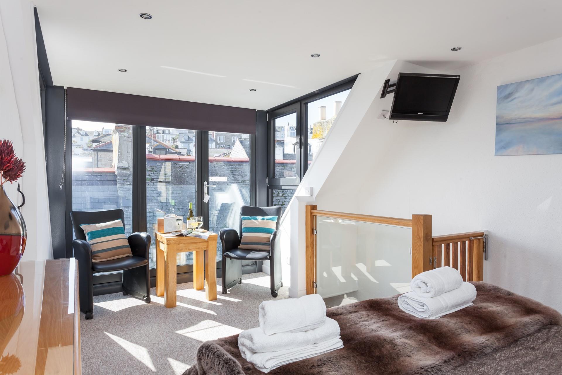 The main bedroom offers a unique layout that adds to the property's character and charm.