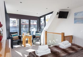 The main bedroom offers a unique layout that adds to the property's character and charm.