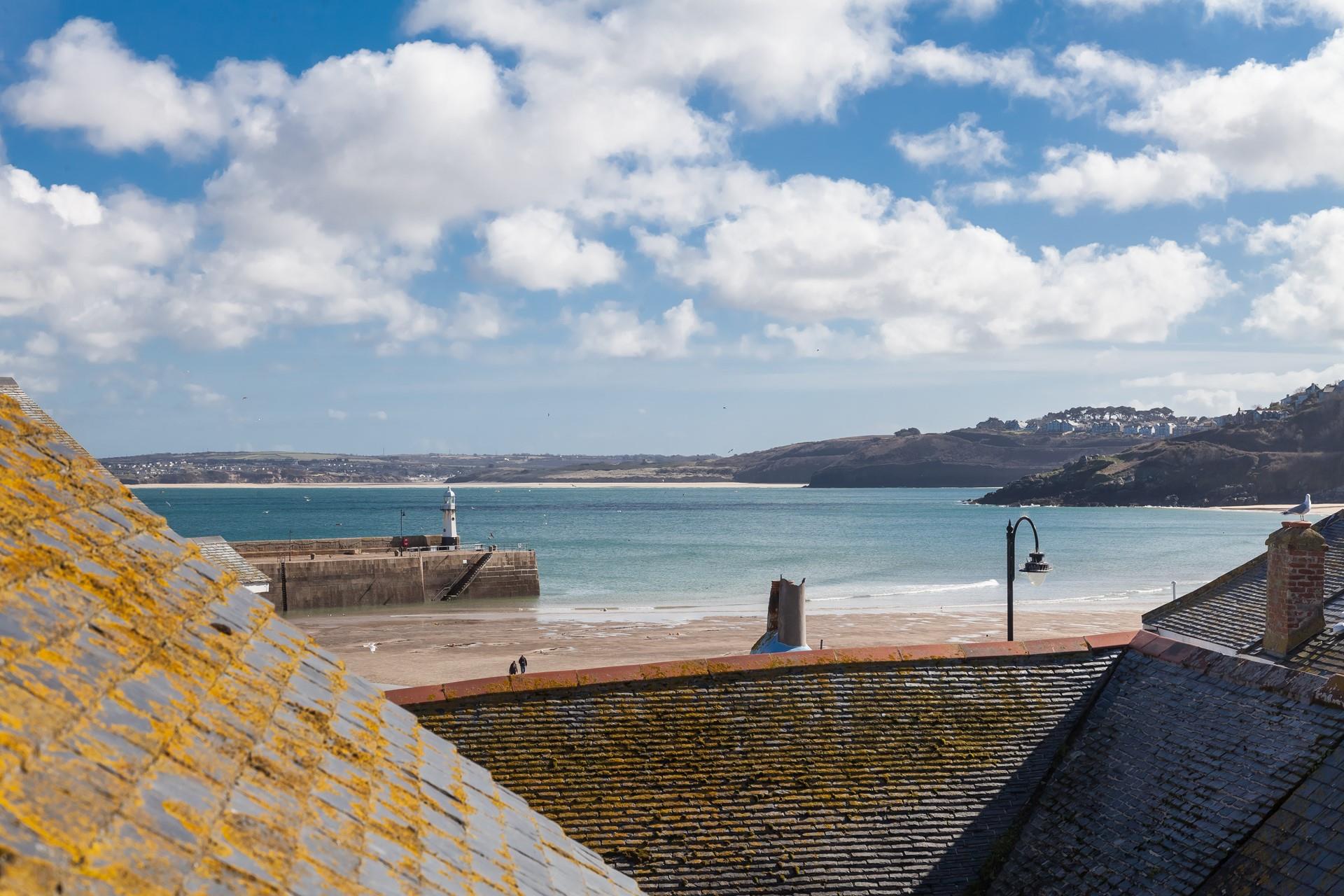 The top bedroom benefits from a fabulous feature window where you can enjoy sea views.