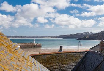 The top bedroom benefits from a fabulous feature window where you can enjoy sea views.