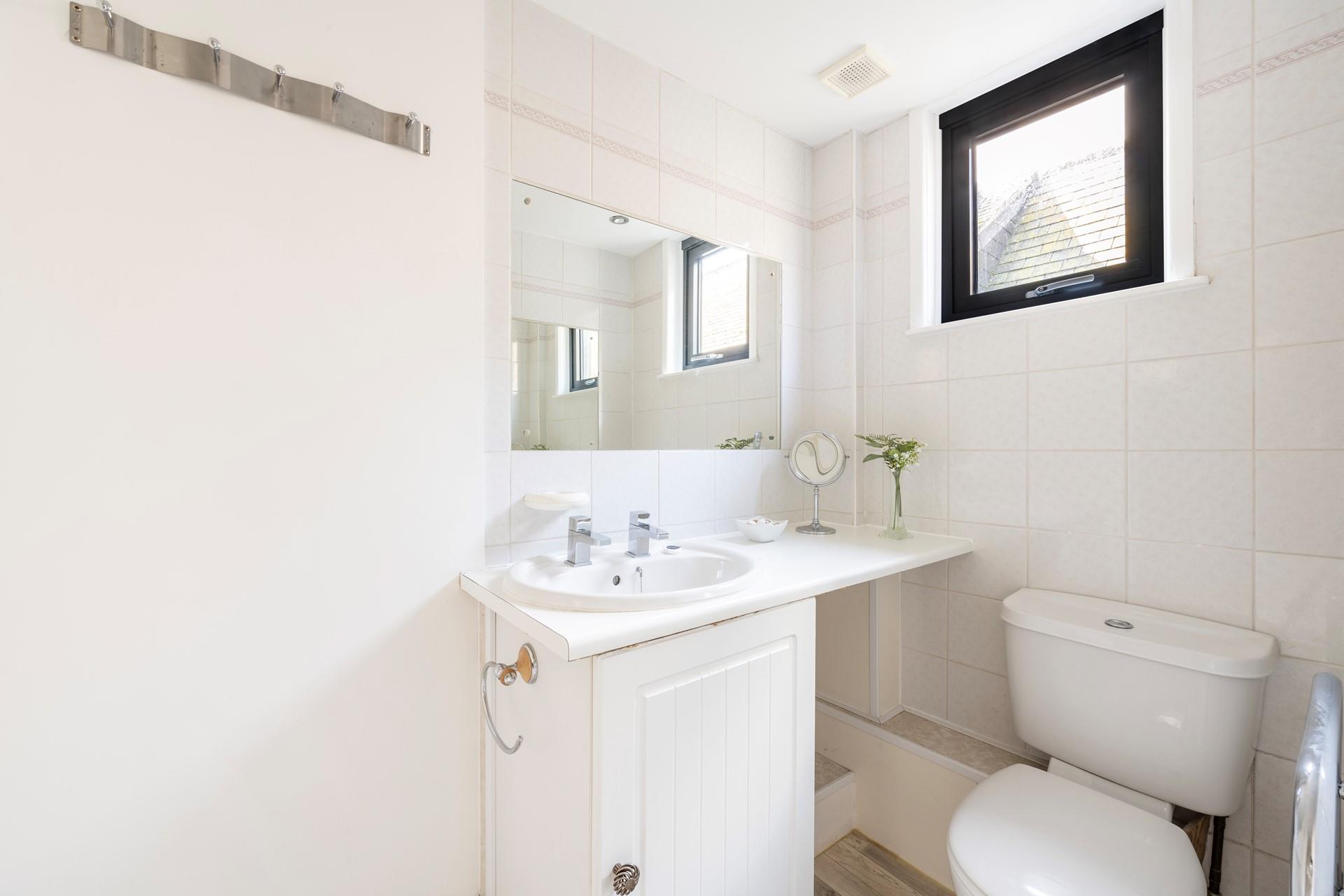 Light and bright, the bathroom is perfect for freshening up before heading out to dinner.