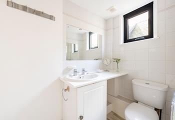 Light and bright, the bathroom is perfect for freshening up before heading out to dinner.