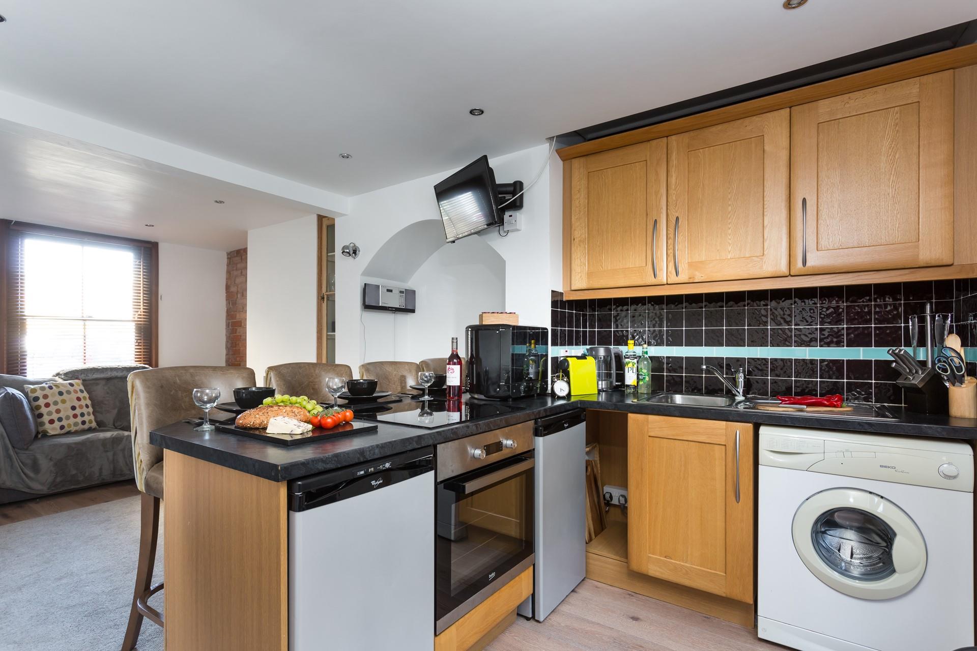 The stylish kitchen benefits from plenty of modern appliances to make cooking up delicious meals a breeze.