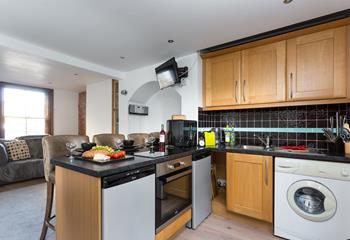 The stylish kitchen benefits from plenty of modern appliances to make cooking up delicious meals a breeze.