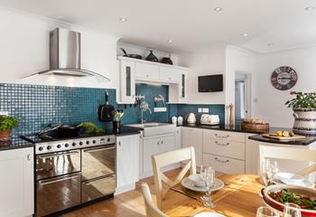The modern kitchen is beautifully designed, mixing a country chic feel with modern fixtures and appliances. 