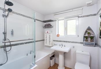 The family bathroom is bright and spacious, perfect for unwinding with a bubble bath after a day on the beach!