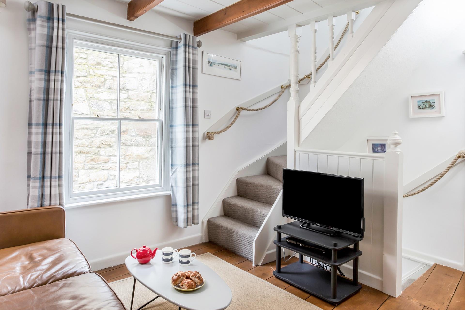 The electric fire sits in the gorgeous original fireplace perfect to keep you cosy during the colder moments.