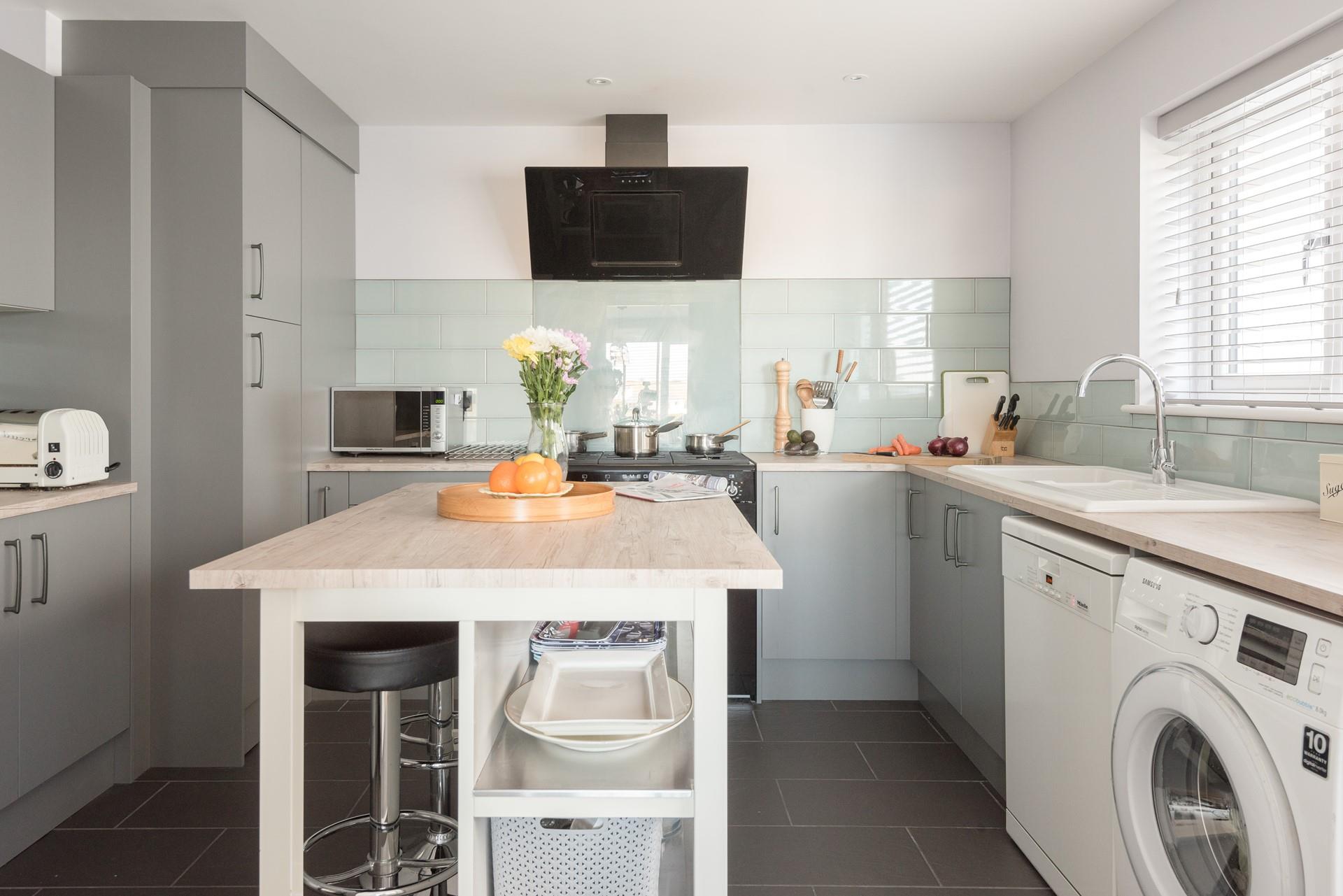 A modern, well-equipped kitchen with a central island means there is plenty of space for preparing a hearty breakfast. 