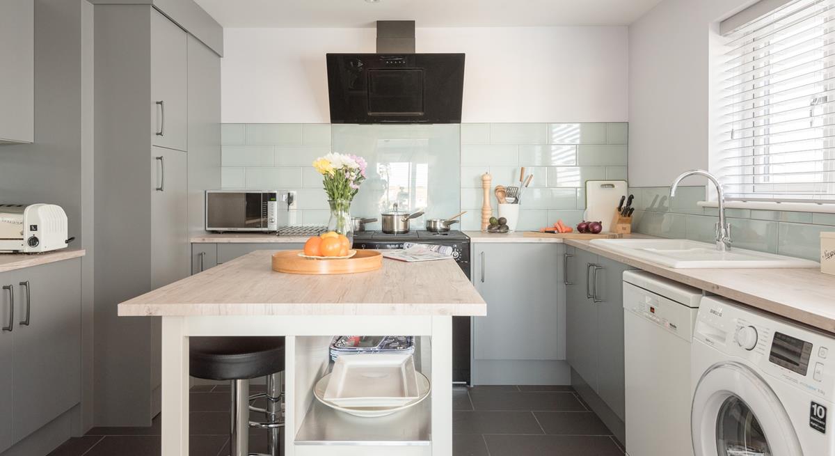 A modern, well-equipped kitchen with a central island means there is plenty of space for preparing a hearty breakfast. 