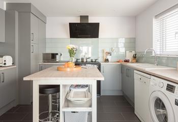 A modern, well-equipped kitchen with a central island means there is plenty of space for preparing a hearty breakfast. 