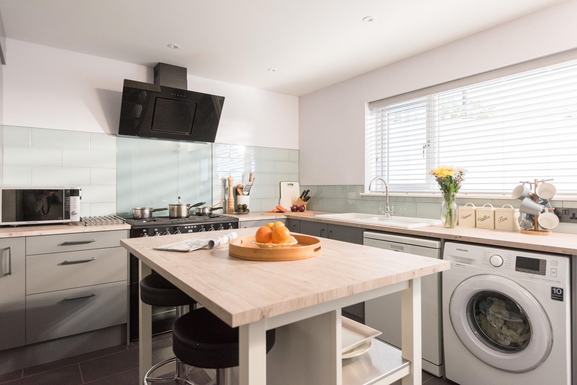 Decorated in pleasing pastel tones, the kitchen is sure to inspire your inner chef.