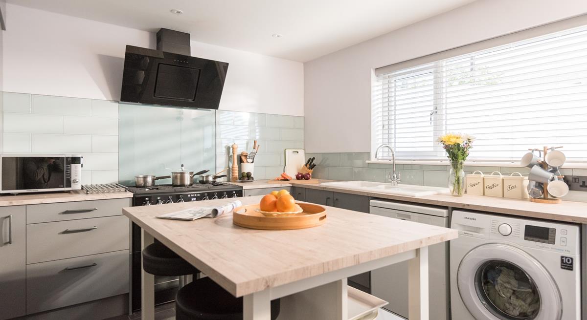 Decorated in pleasing pastel tones, the kitchen is sure to inspire your inner chef.