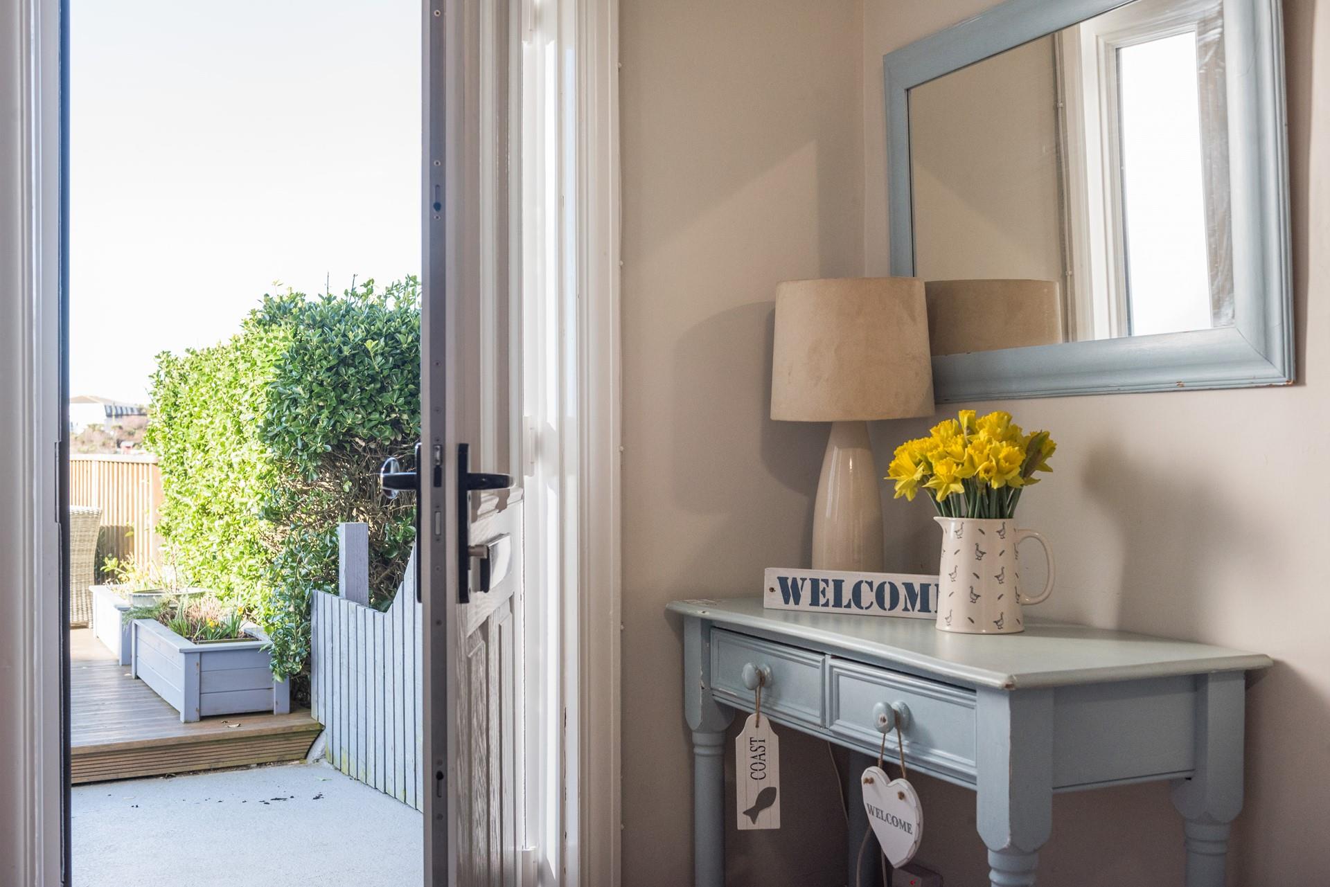 The hallway leads to the decking at the front of the house.
