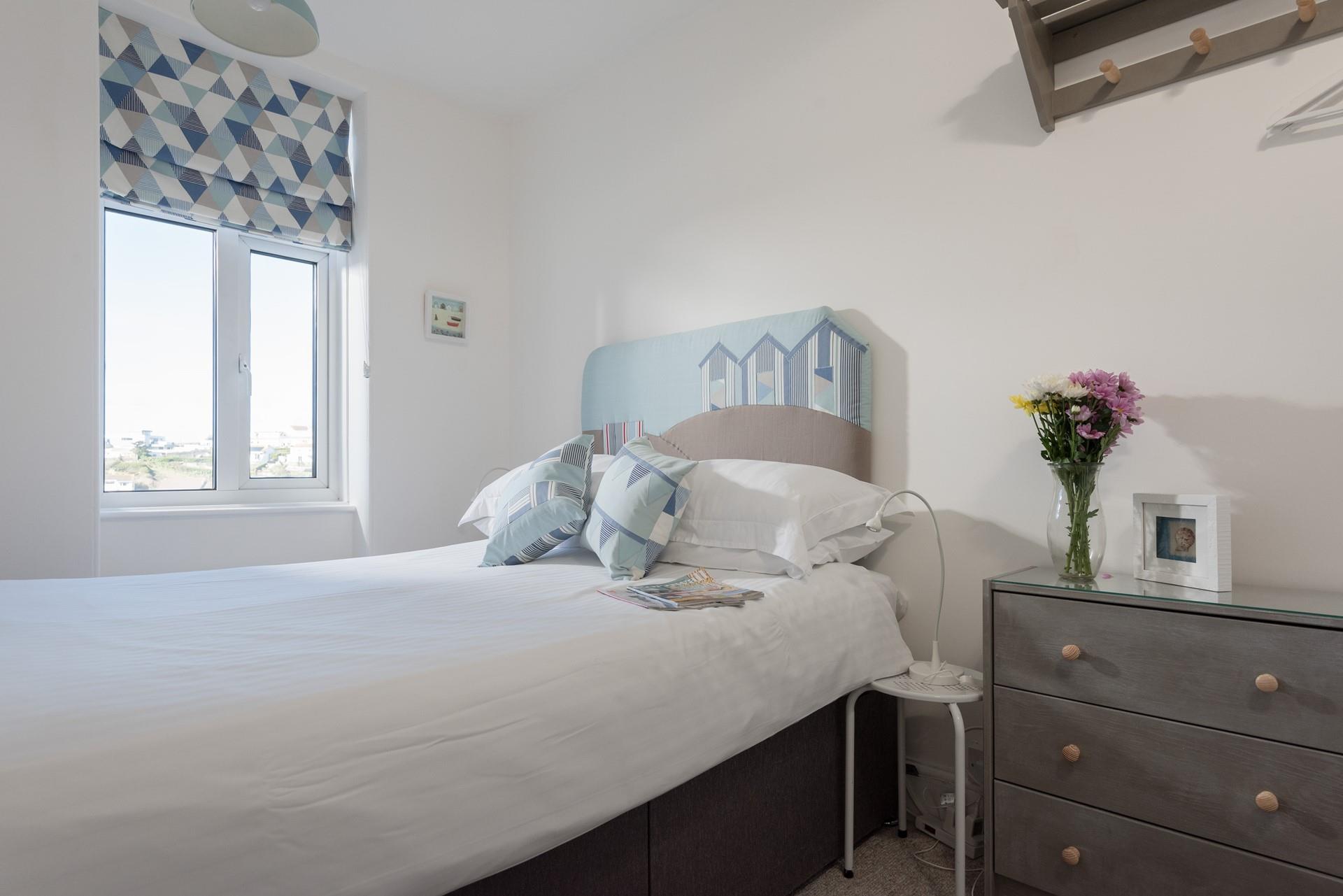 Bedroom 1 has views of the beach that inspired the seaside decor.