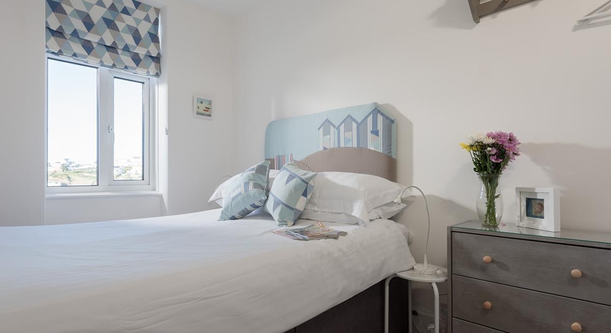 Bedroom 1 has views of the beach that inspired the seaside decor.