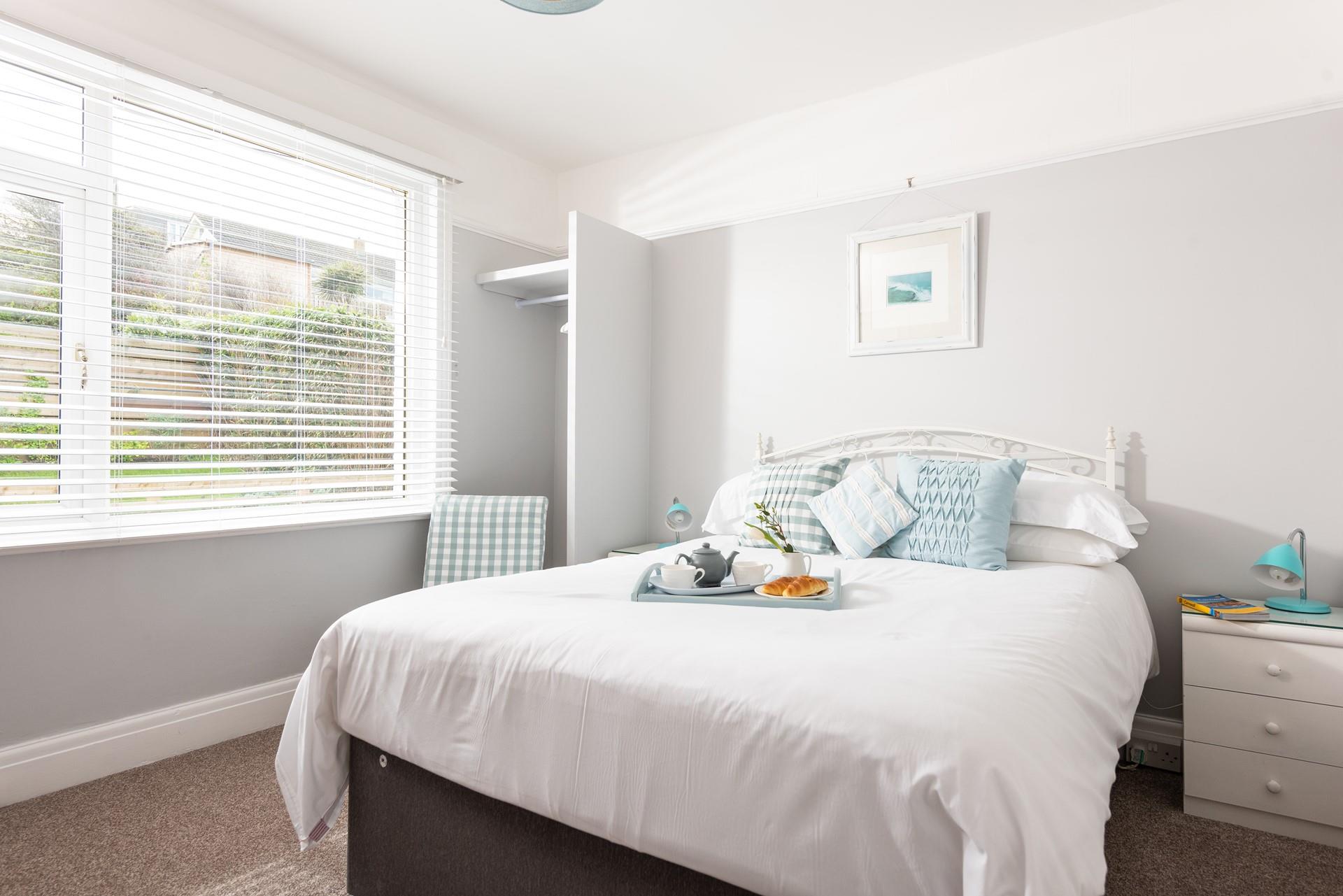 Light and airy, with views of Porth beach and its own en suite. 