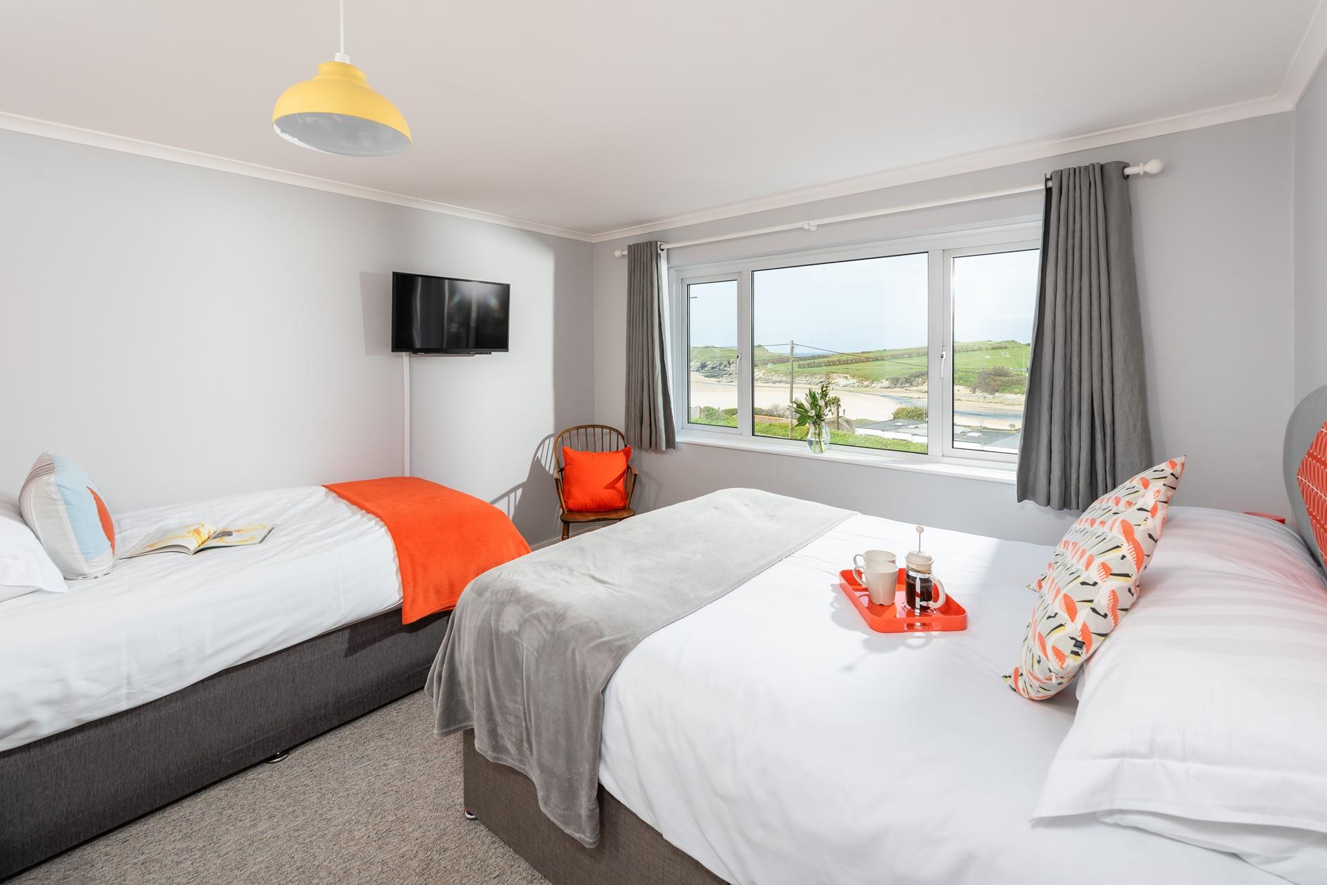 Large windows and pops of colour give the bedroom a bright and stylish feel.