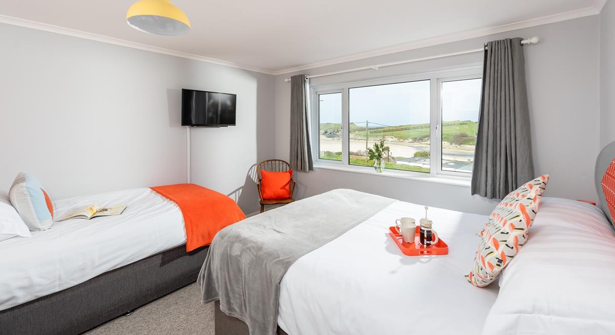 Large windows and pops of colour give the bedroom a bright and stylish feel.