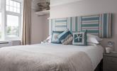 Bedroom 2 is light and airy, with views of Porth beach and its own en suite.  - Thumbnail Image