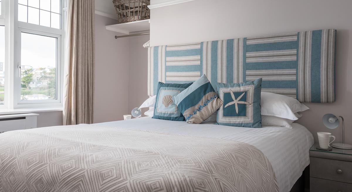 Bedroom 2 is light and airy, with views of Porth beach and its own en suite. 