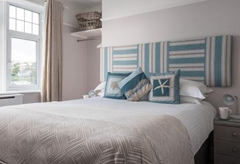 Bedroom 2 is light and airy, with views of Porth beach and its own en suite. 