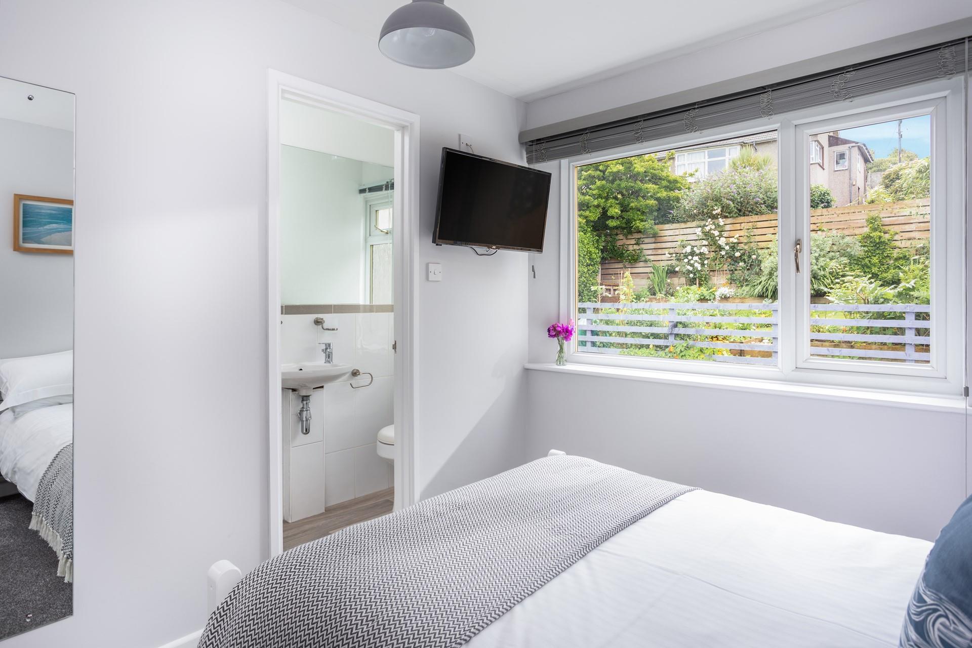 Bedroom 4 has lovely garden views and another handy en suite.
